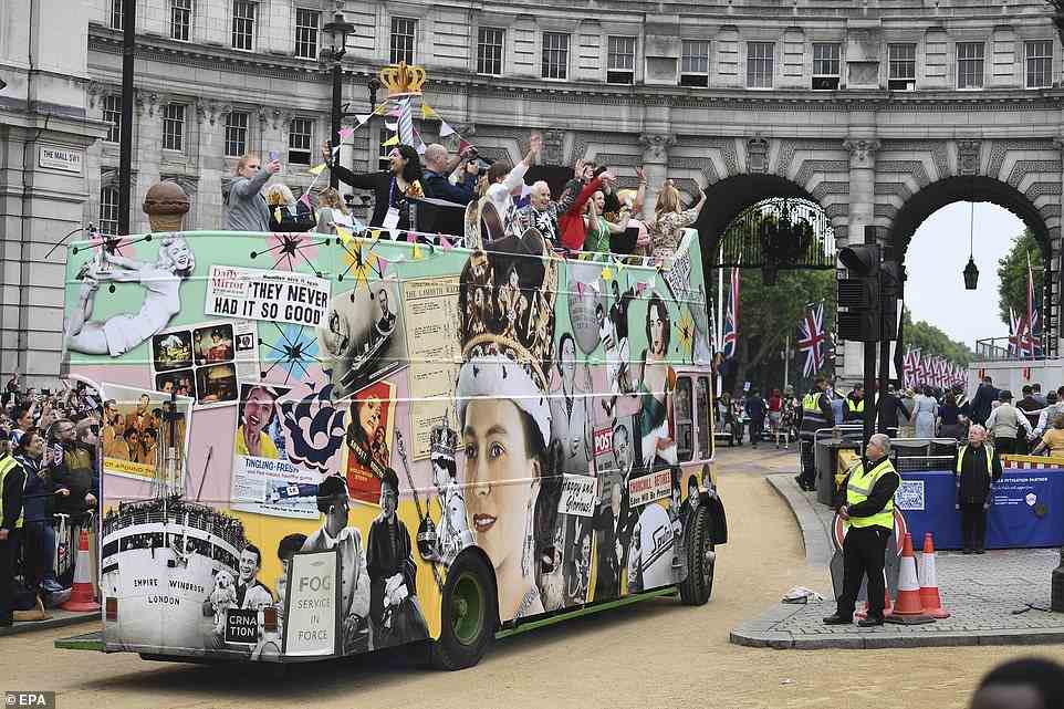 People wave from an open top bus during the Platinum Pageant in London, Britain, June 5, 2022