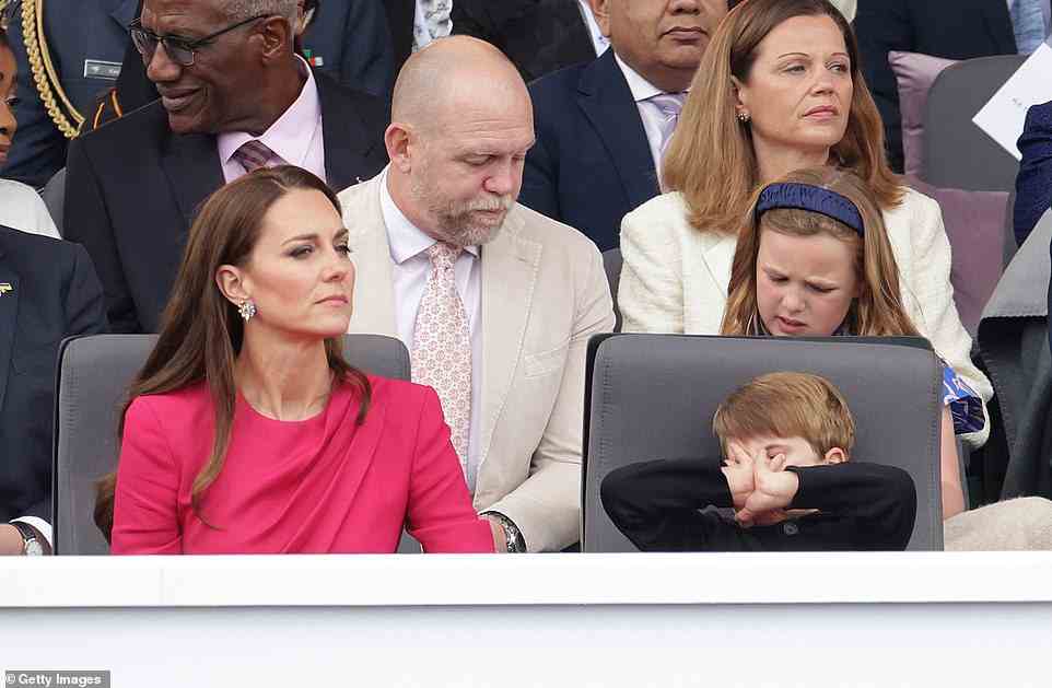 Prince Louis is seen playing in the royal box as his mother Kate Middleton watches the pageant, June 5, 2022
