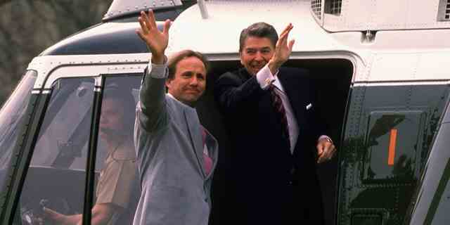 President Ronald Reagan with son Michael Reagan in the doorway of Marine One, departing for California, circa 1988.