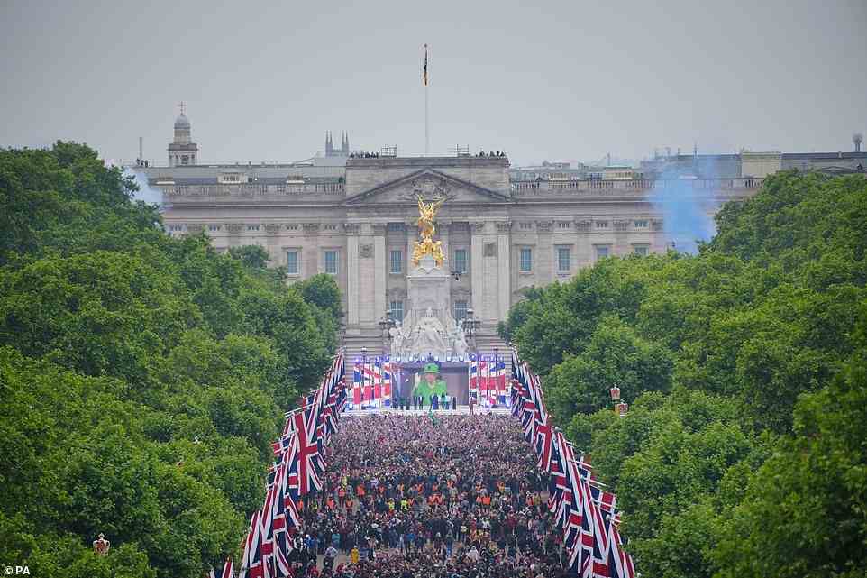 Crowds are seen on The Mall with the Queen shown on a screen during the singing of the National Anthem, June 5, 2022