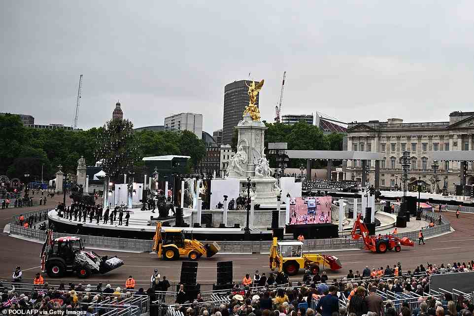 Mechanical diggers parade in front of Buckingham Palace during the Platinum Pageant in London on June 5, 2022