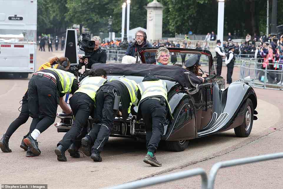 Security staff push Prue Leith's car after it broke down on The Mall, June 5, 2022