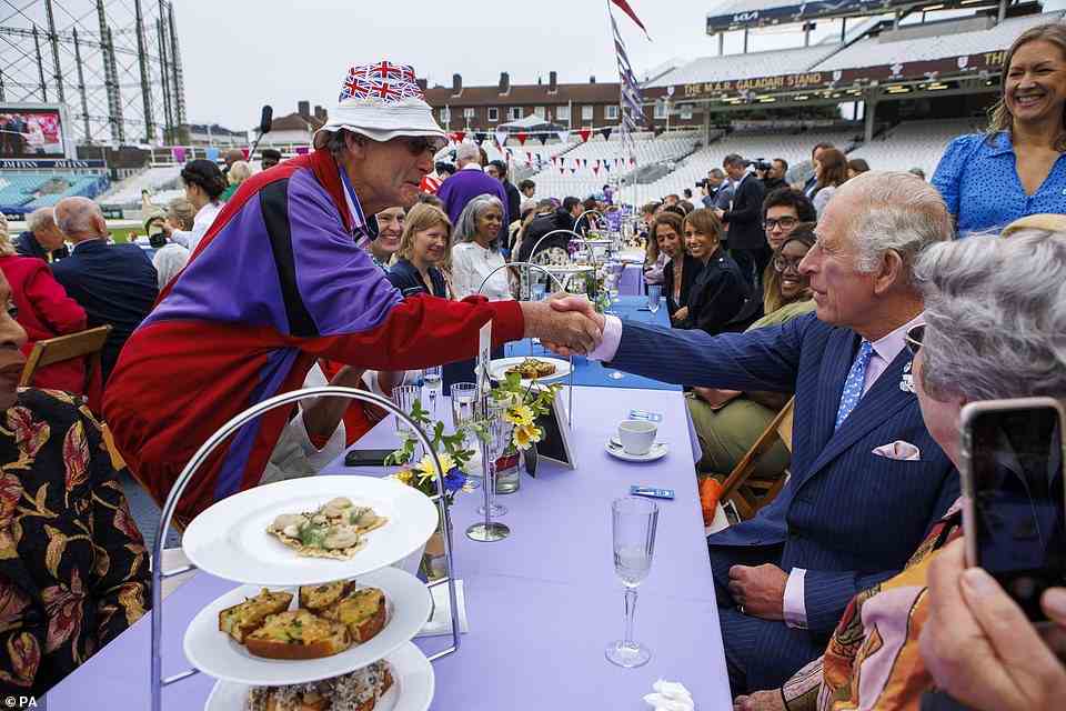 The Prince of Wales shakes hands with a reveller at the Big Jubilee Lunch at the Oval, June 5, 2022