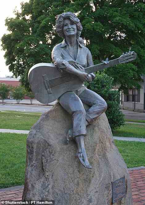 Dolly Parton's proud father used to come down in the dead of night with a mop to wash the pigeon poop off the shoulders of her statue in downtown Sevierville (above)