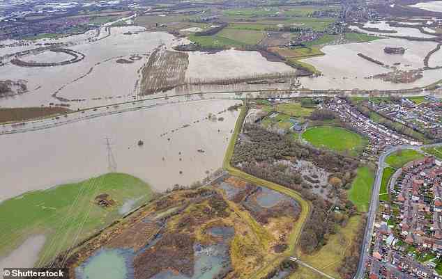 Sea levels are already rising now due to human activities that emit greenhouse gases. Here, an aerial drone photo of the town of Allerton Bywater near Castleford in Leeds, West Yorkshire shows the flooded fields from the River Aire