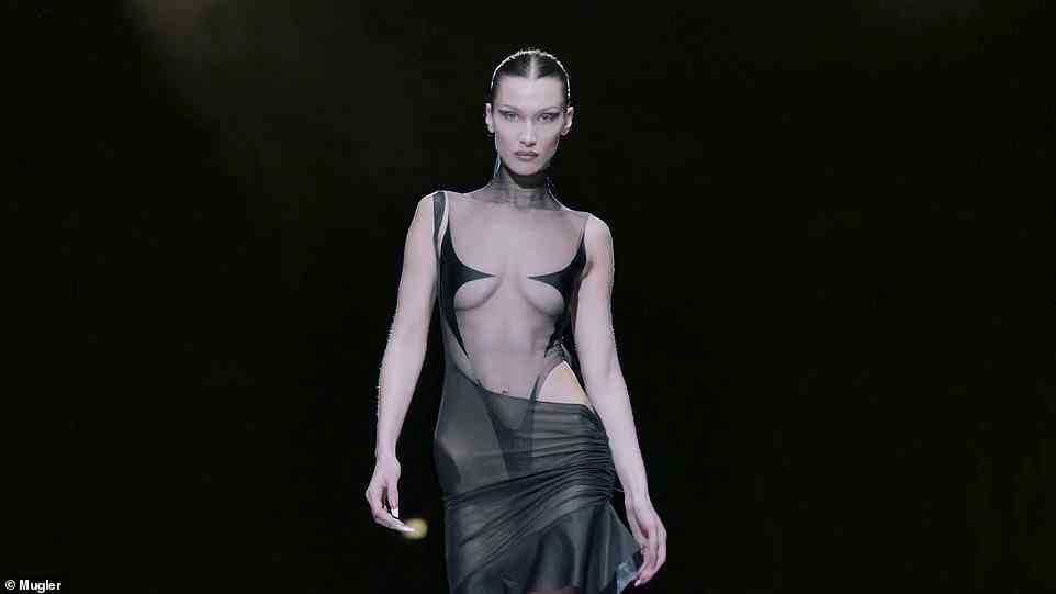 A glow to her: Bella Hadid is seen in a sheer black leotard with a sheer black skirt as her hair is pulled back
