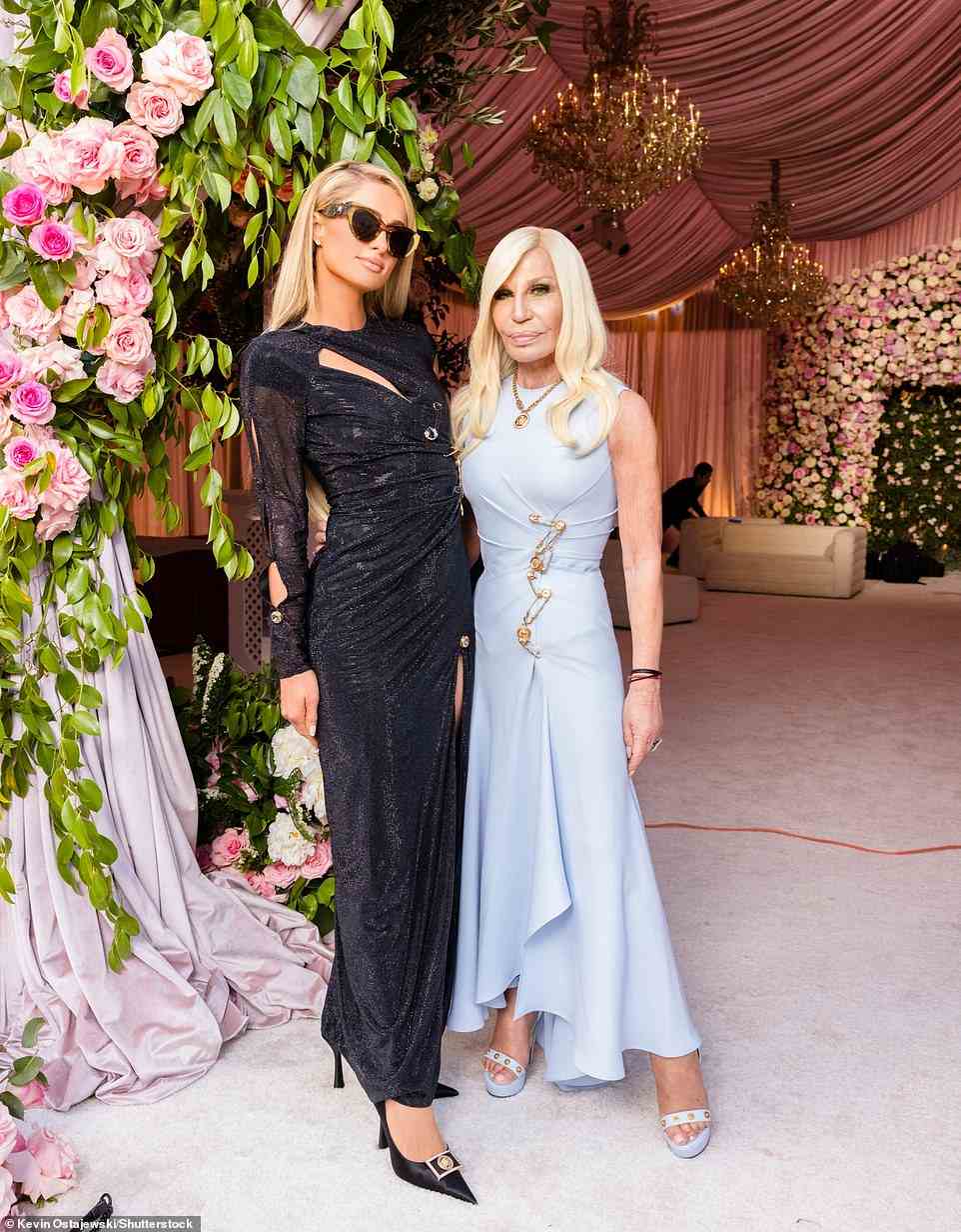 The bride's dress was custom-made by designer Donatella Versace, who was also a guest at the wedding, where she is seen posing with Paris Hilton, who also donned a Versace ensemble