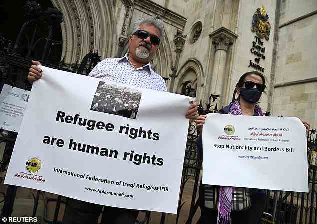 Demonstrators protest outside the Royal Courts of Justice while the legal case over halting the planned deportation, thrown out today by the sitting judge, was heard