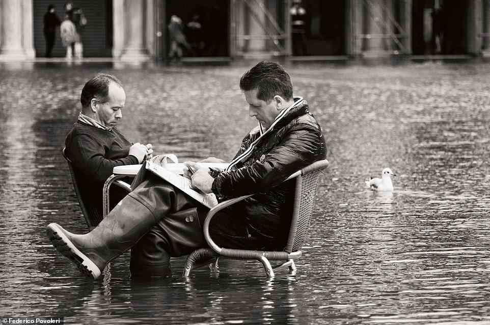 In the book, Povoleri explains how Venice suffers from regular flooding and how it has become 'part of life in the city'. In this image two locals read newspapers at a cafe table while knee-deep in flood waters. Povoleri continues: 'Observing the inhabitants of this city one realises that by no means do they like the constant inundation of their ground. However, they make an effort to accept the coexistence with a kind of brotherly tolerance'