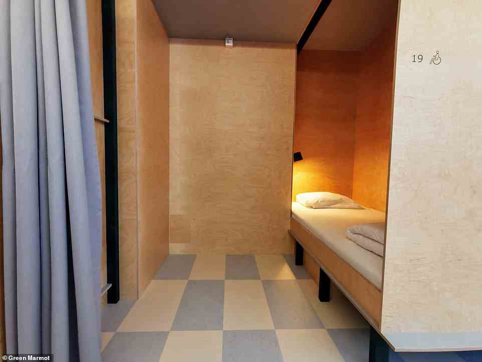 A wheelchair-accessible bunk space. 'In the Green Marmot capsule hotel you're in your own burrow, like a marmot, and only catch sight of others when they choose to show themselves, also like a marmot,' writes Carlton