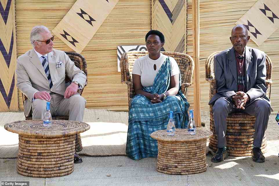 Prince Charles, Prince of Wales listens to a genocide victim (centre) and a perpetrator who has been pardoned (right) taking about their experiences during his visit to the Mybo reconciliation village in Nyamata