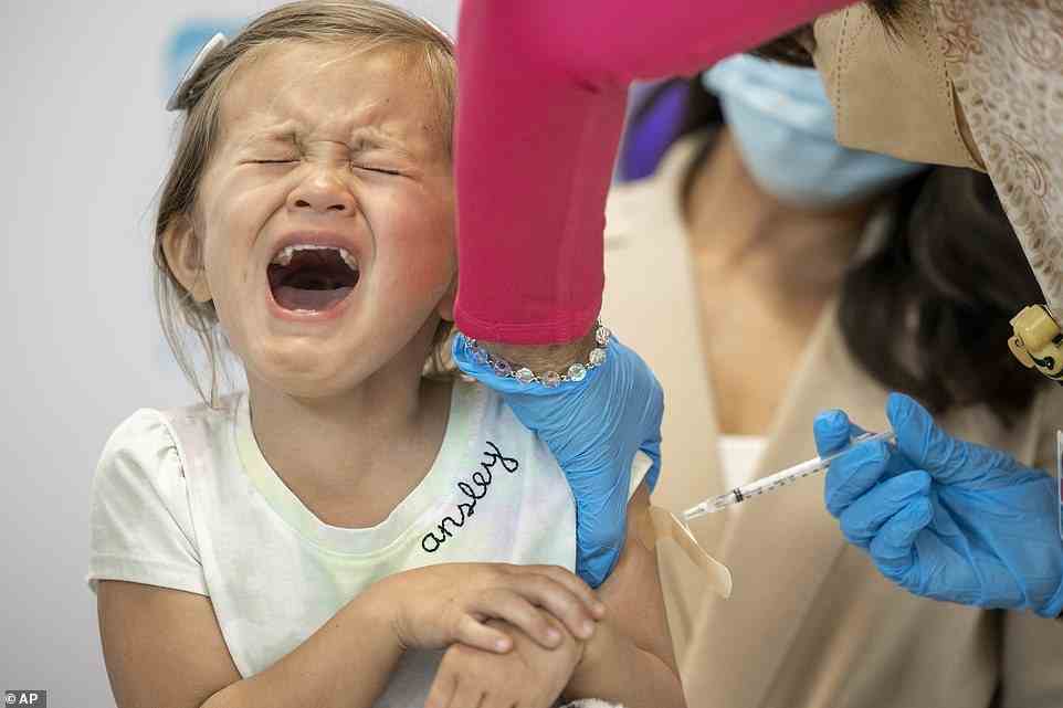 Pictured: A four-year-old girl reacts in agony as she receives a shot of a COVID-19 vaccine in New Orleans, Louisiana on Tuesday