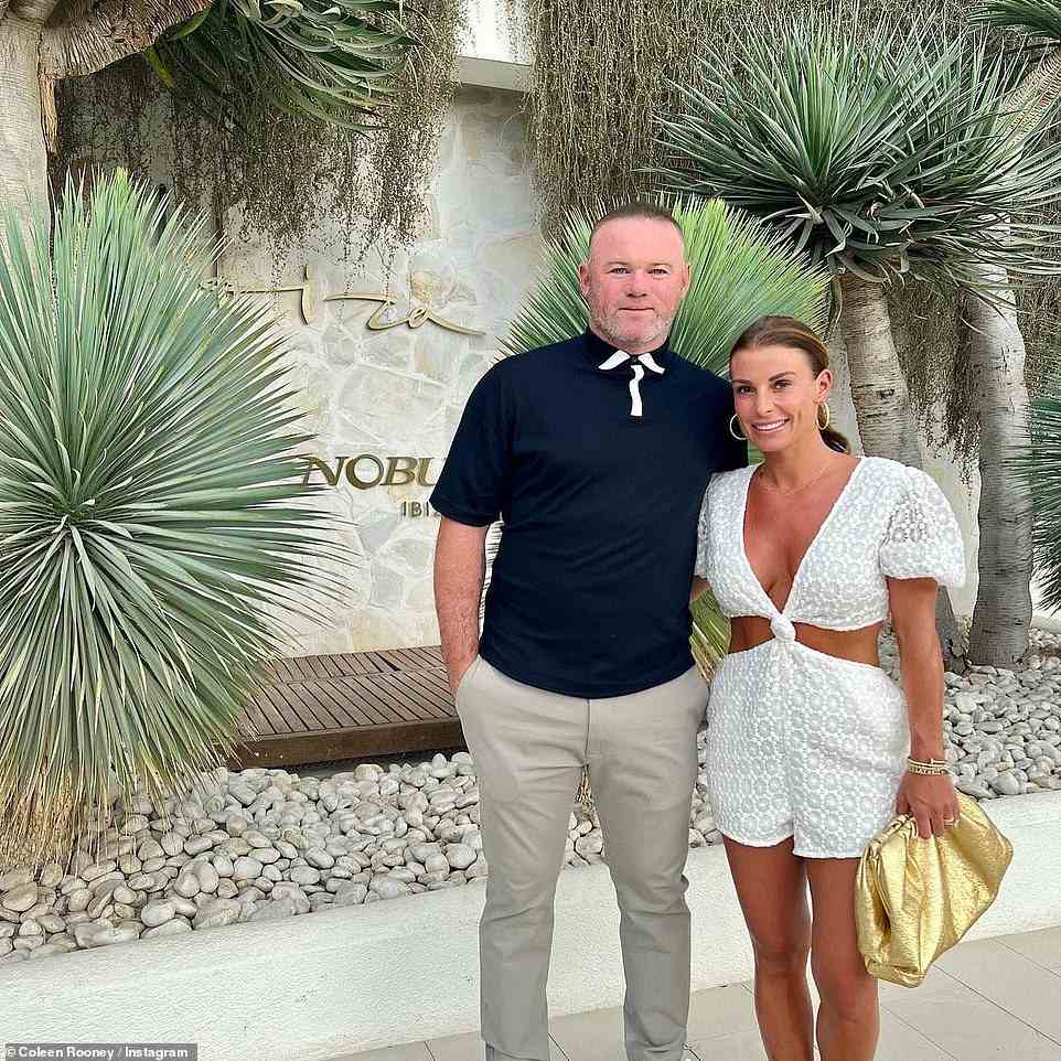 Stunning: Coleen looked effortlessly chic in a plunging white playsuit while flashing her toned and tanned abs through the cut-out detail
