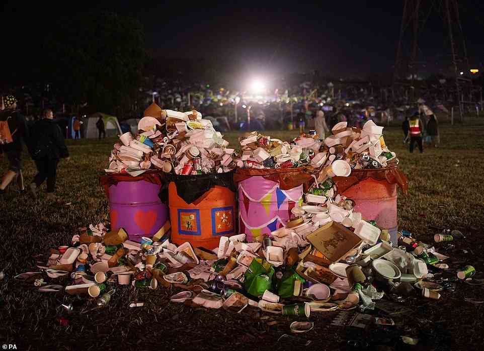 A load of rubbish: overflowing trash bins show the signs of thousands of happy revellers after Billie Eilish's Pyramid Stage set
