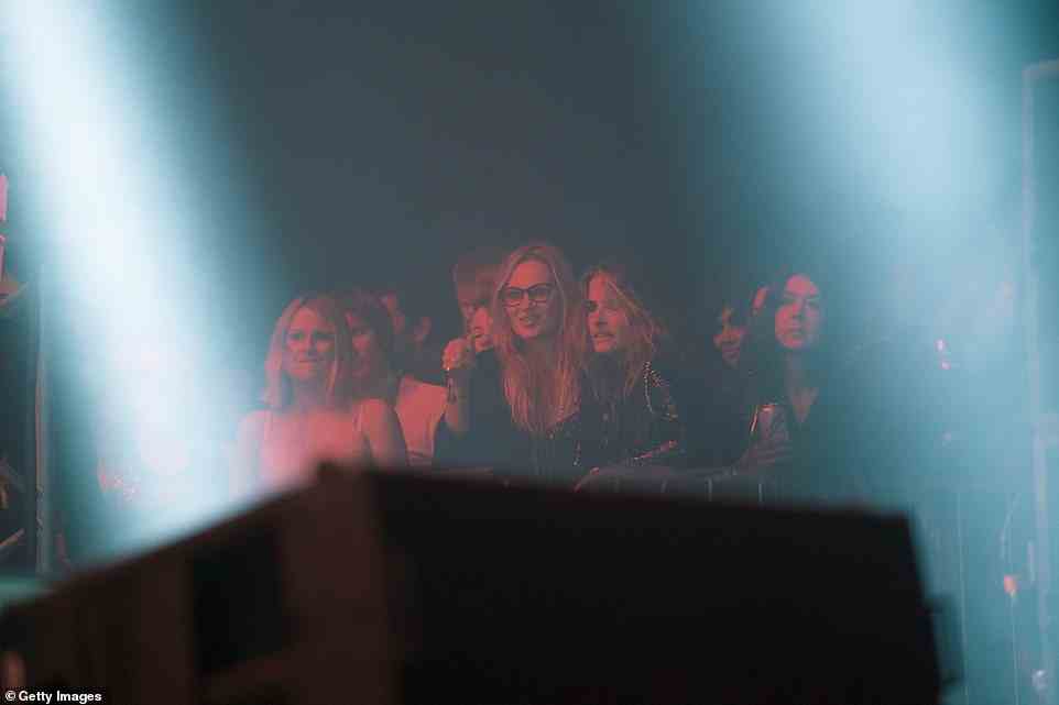 Celeb audience: Kate Moss stood on the sidelines to watch Primal Scream with a group of pals at Glastonbury