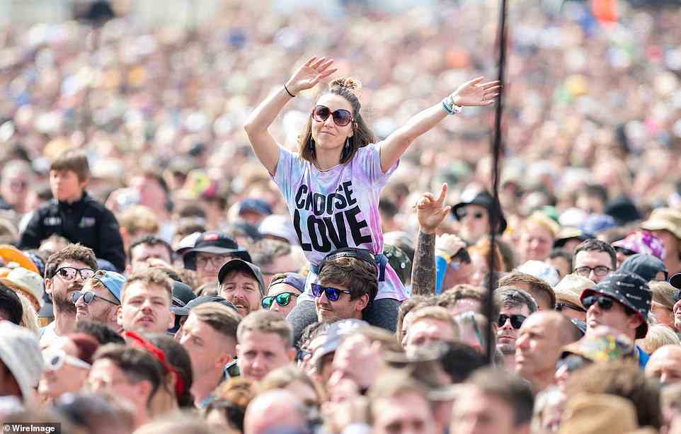 A festival goer enjoys the music during day three of Glastonbury Festival at Worthy Farm in Somerset today