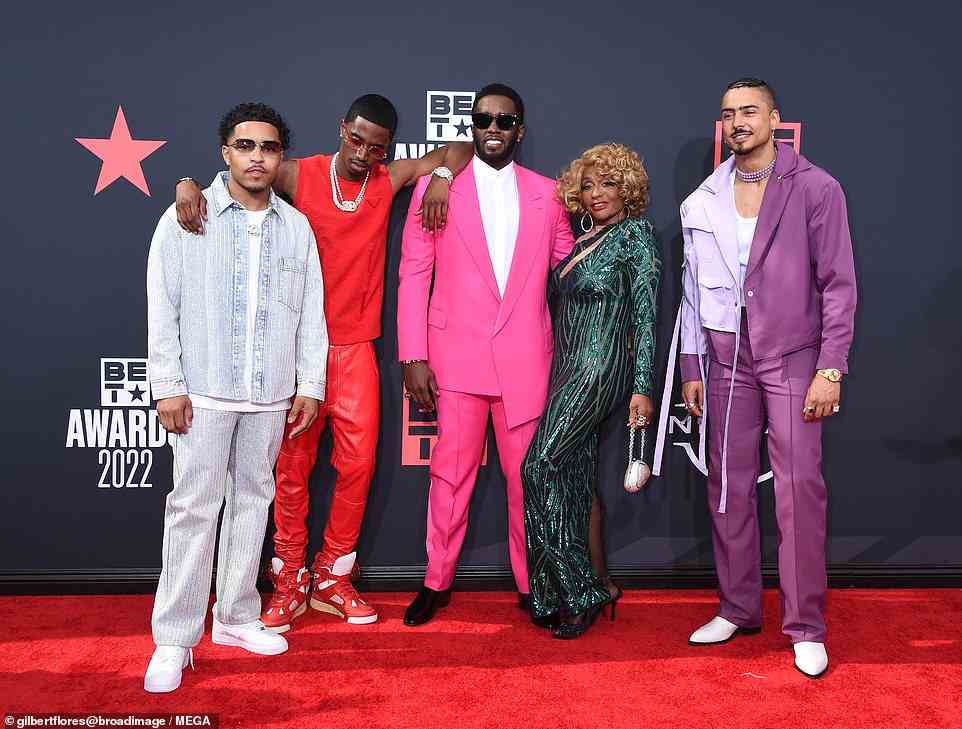 All together: Combs looked thrilled as he posed with his family on the red carpet
