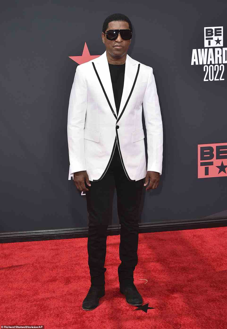 Suave: 12 time Grammy winner Babyface, 64, looked sophisticated in a white suit jacket with a black trim worn over a black shirt and matching jeans