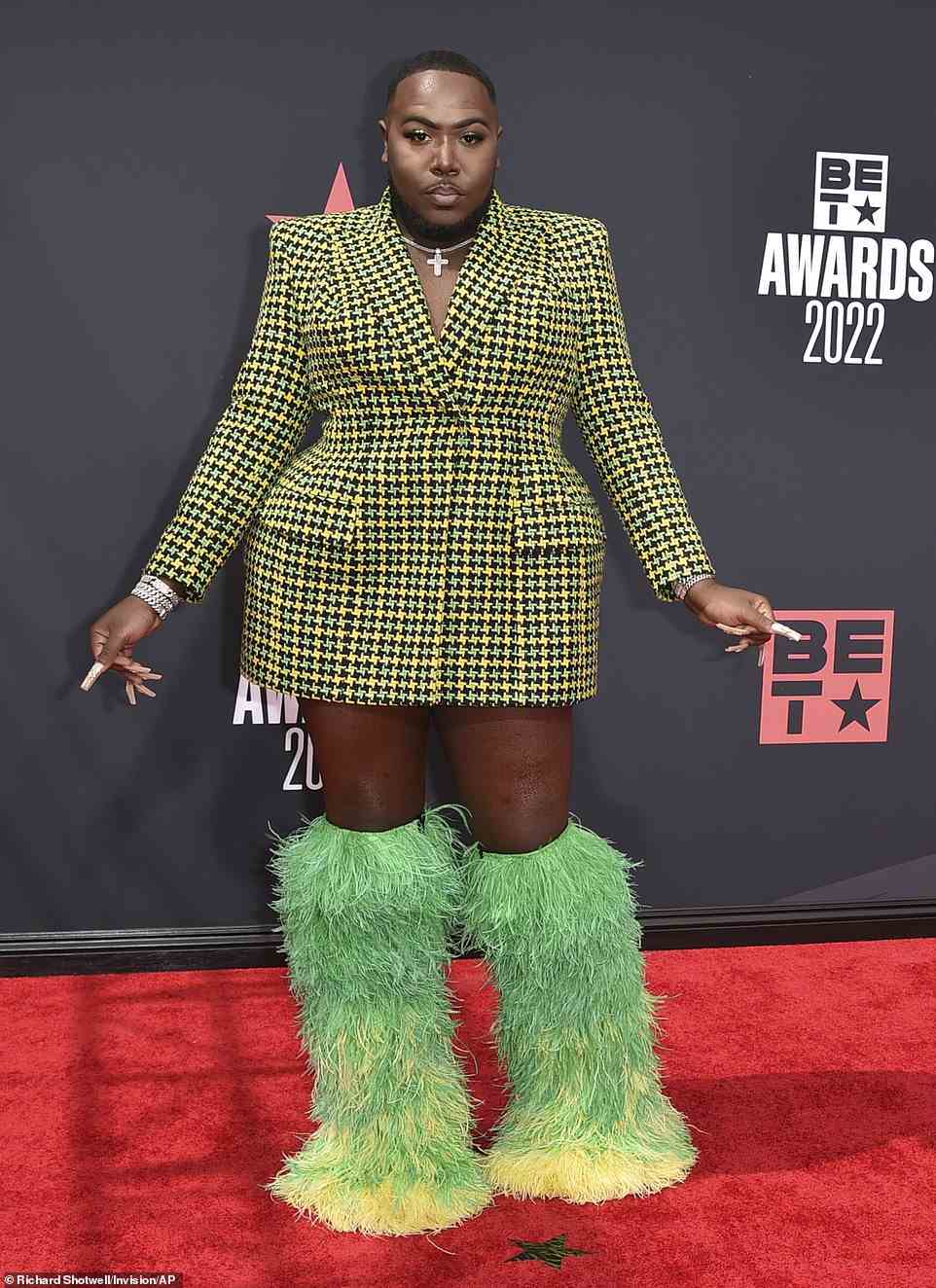 These boots were made for walking! Rapper Saucy Santana, 28, made quite the entrance in a plaid green and yellow structured blazer dress and massive furry boots