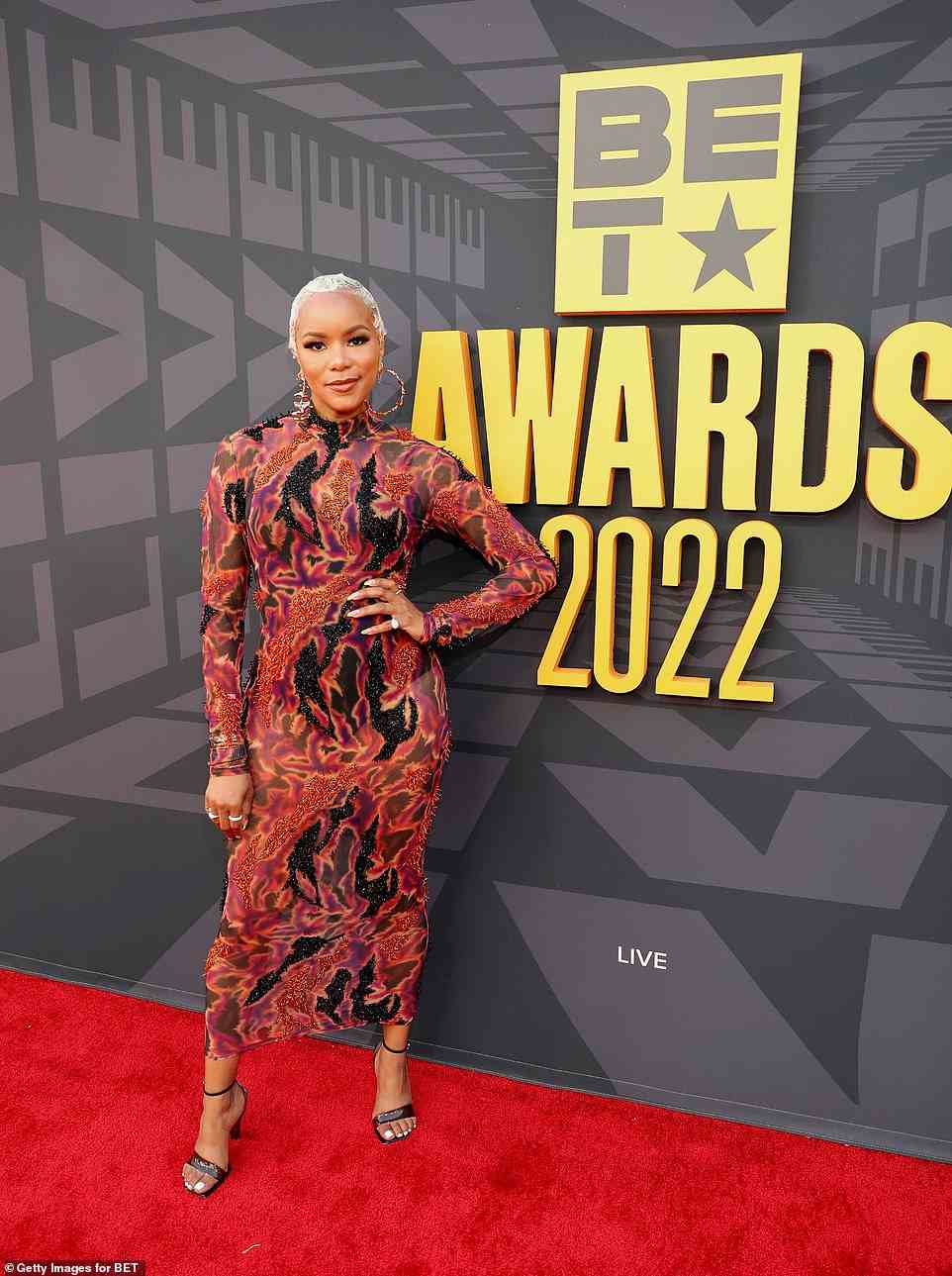 Funky style: LeToya Luckett, 41, looked cool as ever in a multi-color form-hugging dress, gold hoops, and black heels