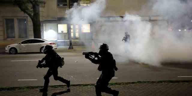Riot police run at protesters while firing tear gas during nationwide unrest following the death in Minneapolis police custody of George Floyd, in Raleigh, North Carolina, U.S. May 31, 2020.