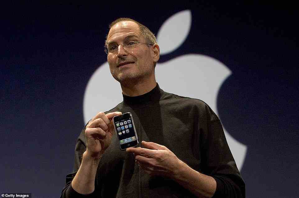Apple CEO Steve Jobs holds up the new iPhone that was introduced at Macworld on January 9, 2007 in San Francisco, California. The device first went on sale on June 29 that year