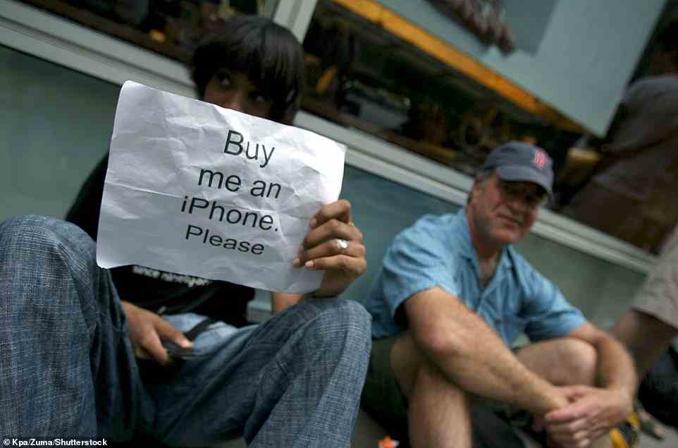 'Buy me an iPhone please': One young hopeful in New York attempts to get the device on the day of its release, on June 29, 2007