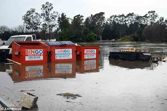 Inundated waste bins in Camden, south-western Sydney, as wild weather batters the state