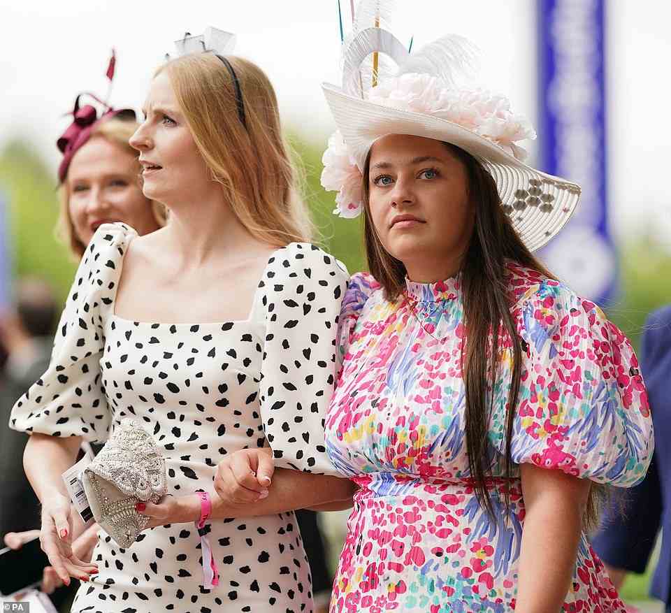 Glamorous revellers donned fabulous headpieces and vibrant frocks as they descended on Newmarket racecourse for Ladies Day today