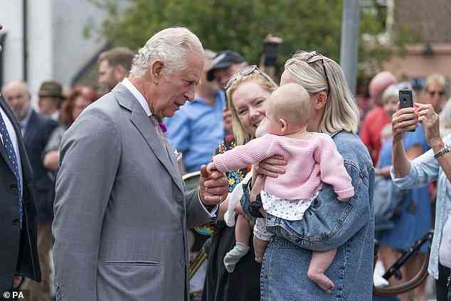 A very young royal fan and her mother caught the attention of the Prince of Wales, and he let her wrap her tiny hands around his finger