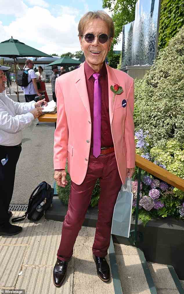 Good look! Also at the match was singer Cliff Richard, 81, who wore a striking pink suit and tie as he beamed for the cameras