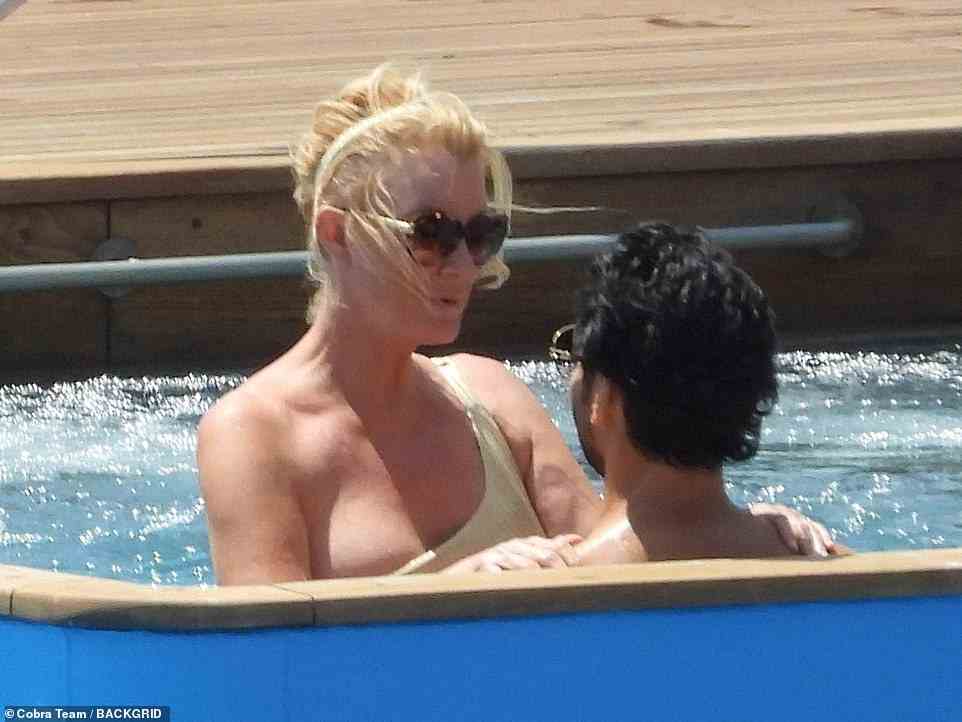 Lee's one-strap swimsuit gave Youcef ample view of her décolletage when she was standing in front of him