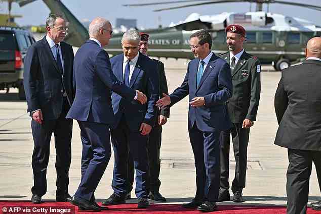 President Joe Biden shakes the hand of Israel's President Isaac Herzog (third from right), while Prime Minister Yair Lapid (center) also sends off the American president from the Ben Gurion Airport tarmac Friday afternoon