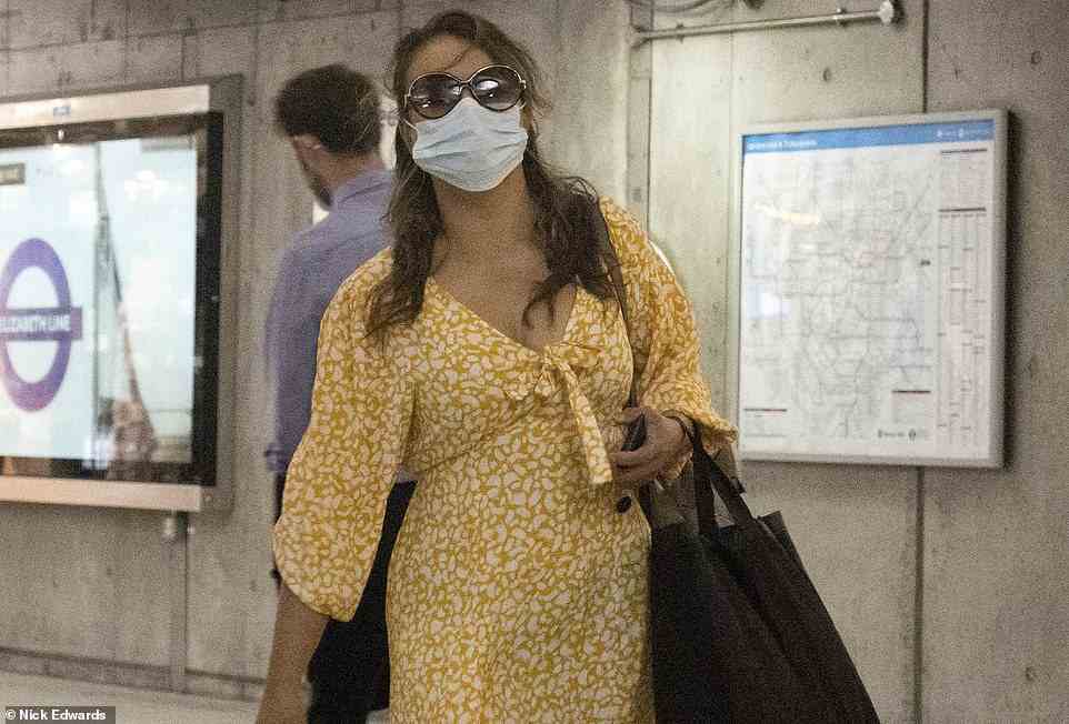 A woman on the Jubilee Line in London on Thursday wearing a medical face mask. Face coverings were previously mandatory but are now optional