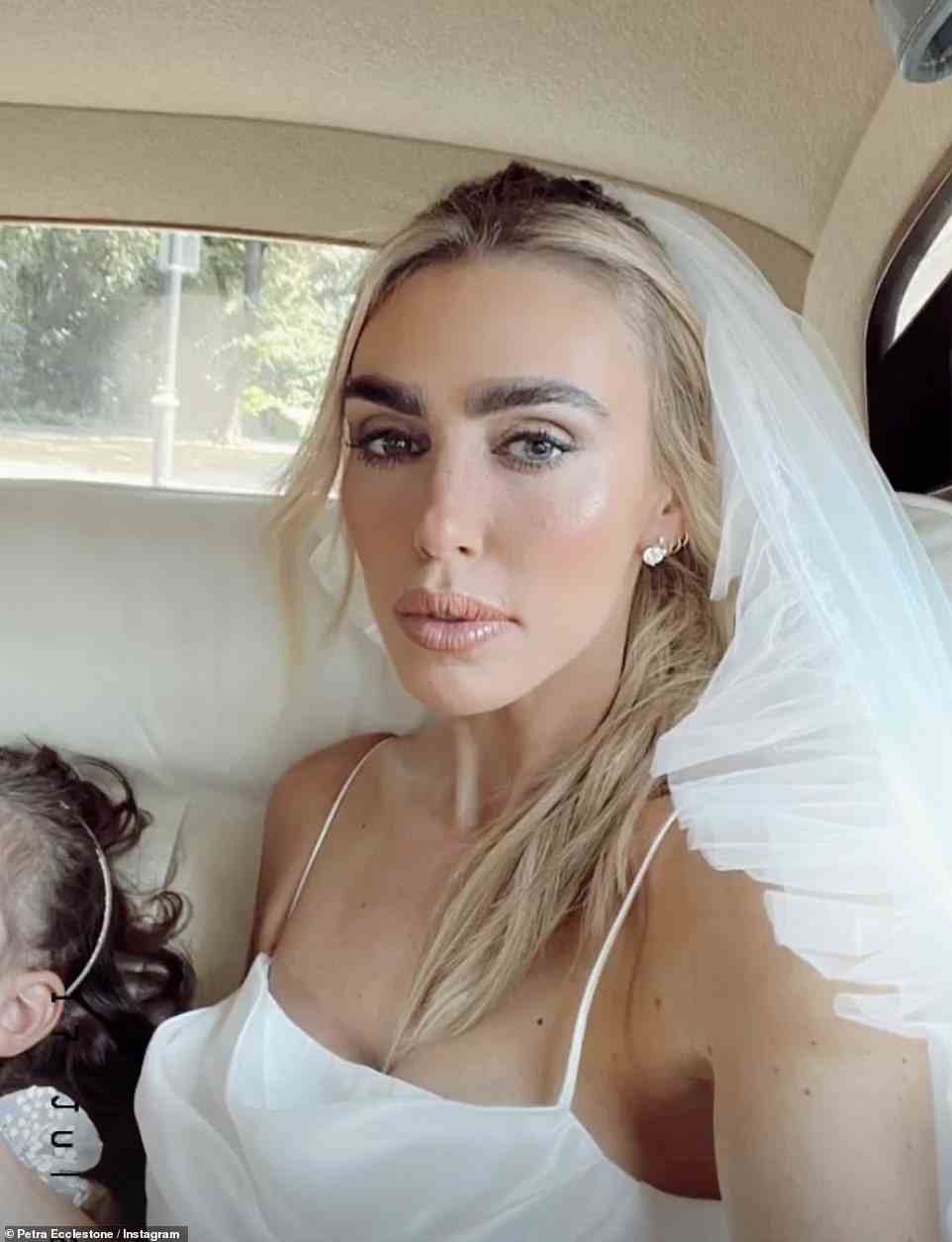 Beautiful: Petra also gave a behind-the-scenes look at her wedding day as she posed for a picture in the back of the car as she travelled to the venue
