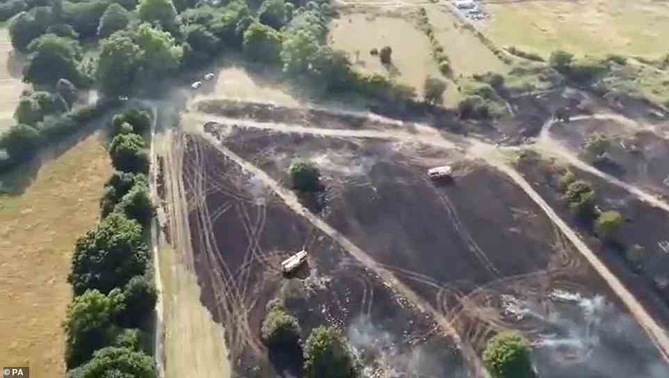 Drone footage of the aftermath of a field fire by Cheshunt Park in Hertfordshire pictured today, after it started yesterday