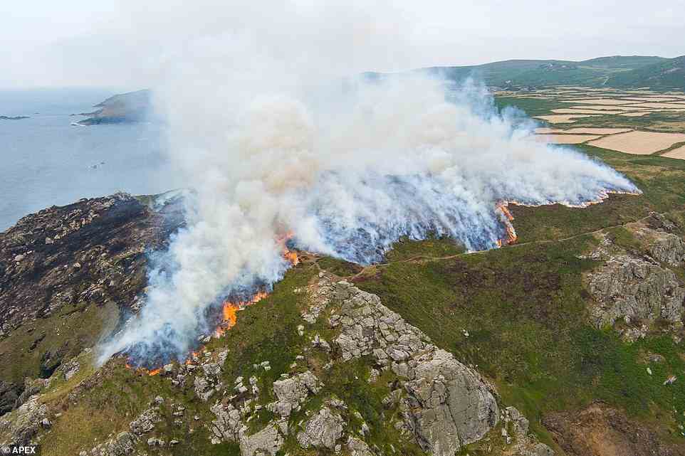 Huge smoke plumes are seen as a fire sparked by lightning at Zennor Head, West Cornwall rages in the afternoon