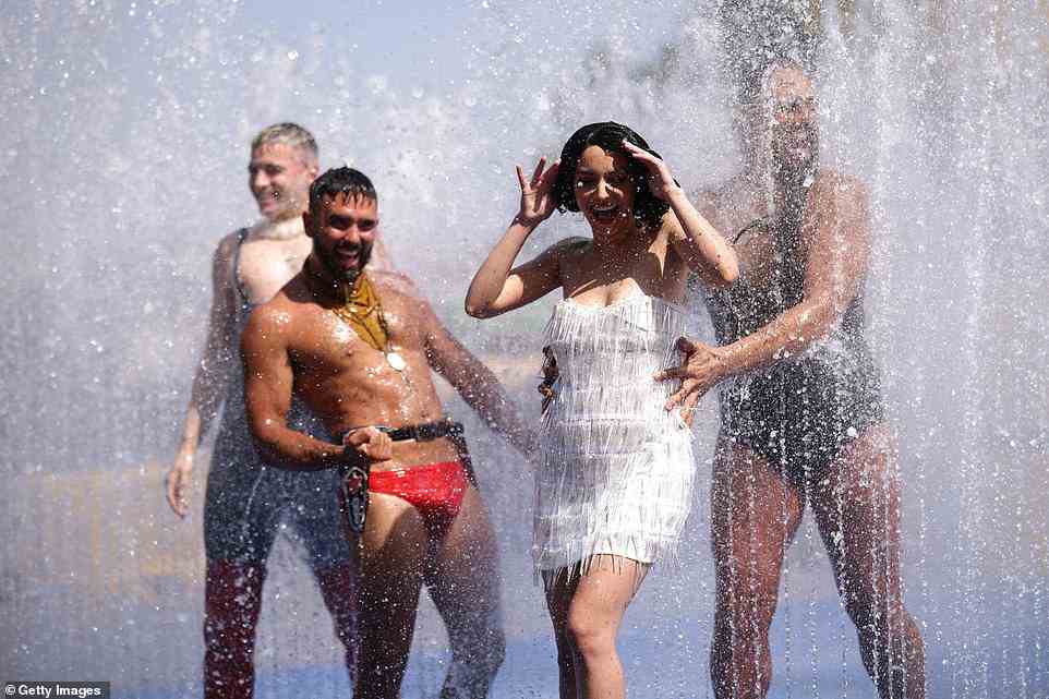 Australian cabaret and circus troupe Briefs take to the water to attempt to cool themselves during a photocall for "Bites" outside the Queen Elizabeth Hall in London today