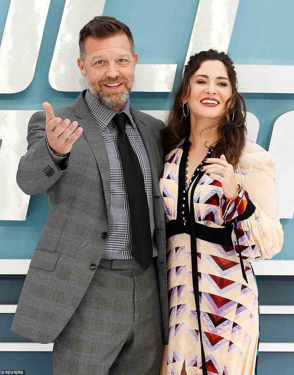 Beaming: Bullet Train's director David Leitch was joined by his wife, and the film's producer Kelly McCormick, with the happy couple posing for snaps together at the premiere