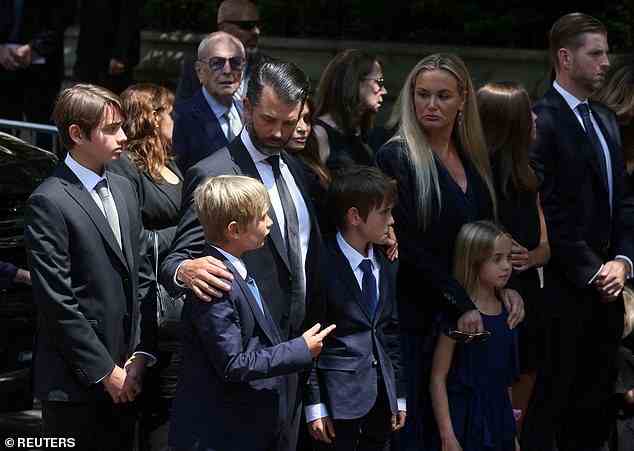 Donald Trump Jr. comforts two of his sons at the funeral of their grandmother Ivana on Wednesday