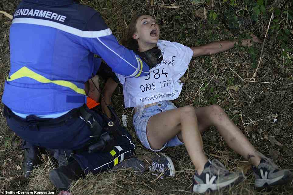 A protester is held by police wearing a T-shirt saying there are 984 days left as she is arrested earlier this month  on July 17