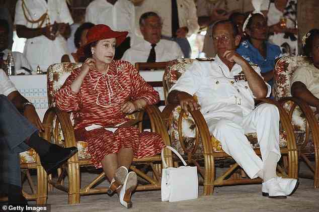 Prince Philip smiles at his wife the Queen while they sit down after their arrival in Kiribati, during their South Pacific tour, on 23 October 1982.