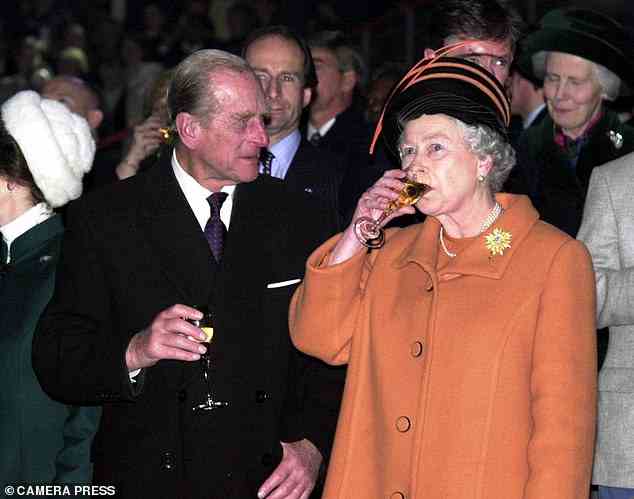 Down the hatch: The Duke watches in admiration as the Queen takes a hearty sip of champagne as they see in the new millennium on December 31, 1999