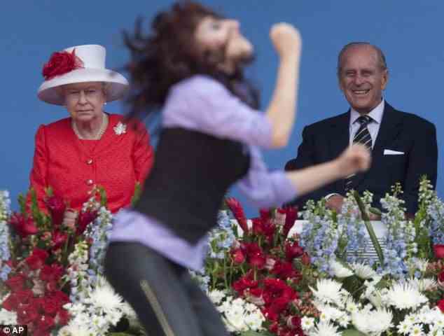 Mixed reaction: As a dancer throws some moves in front of the royal couple, the Queen does not seem to share the same enthusiasm as her husband Prince Philip