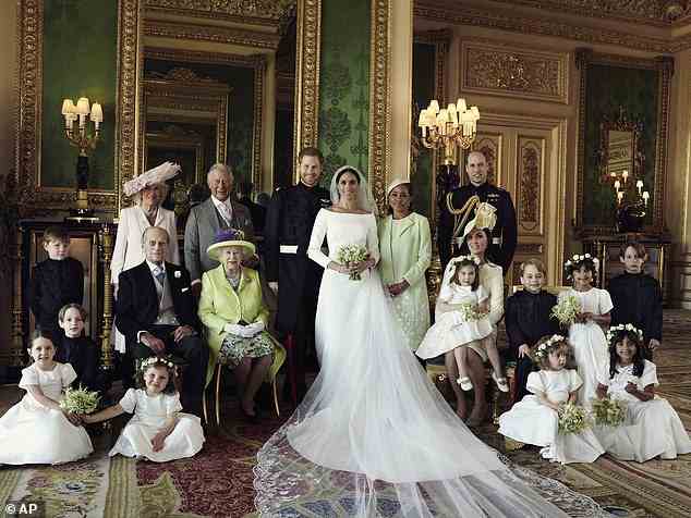 An official wedding photo of Prince Harry and Meghan Markle, the Queen and the Duke of Edinburgh are pictured sitting to the left of the bride and groom