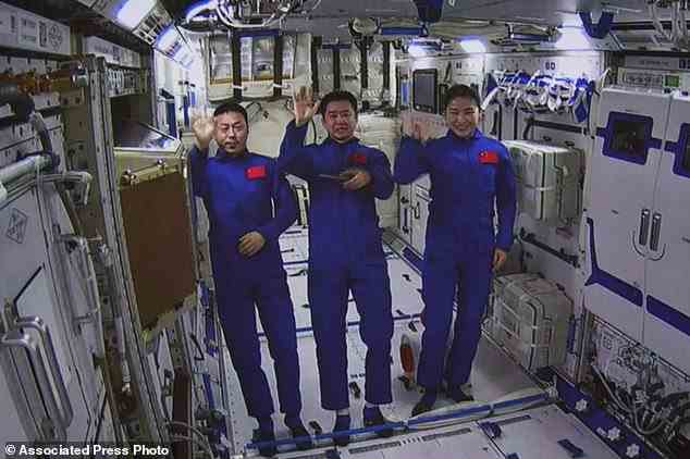 Auf diesem von der Nachrichtenagentur Xinhua veröffentlichten Foto zeigt ein vom Bildschirm des Beijing Aerospace Control Center aufgenommenes Bild die chinesischen Astronauten von links, Cai Xuzhe, Chen Dong und Liu Yang, die am Montag, dem 25. Juli 2022, aus dem Wentian-Labormodul winken