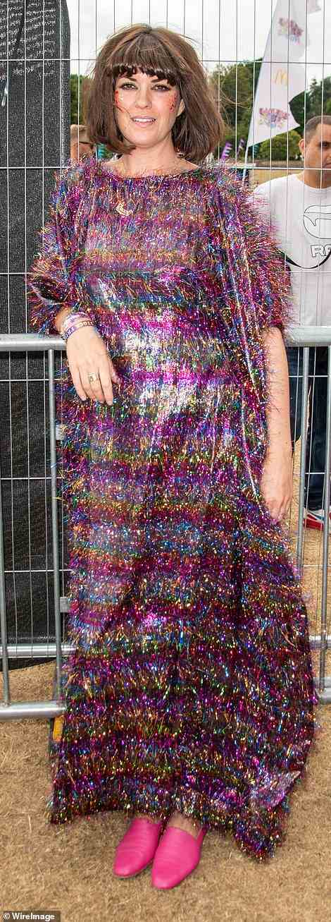 Wow! Dawn O'Porter, who also counted the late star as a dear pal, commanded attention in a fluffy purple maxi dress with yellow, blue and pink shimmering stripes