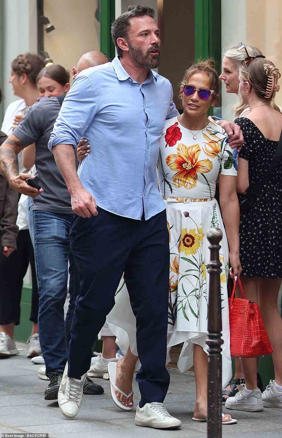 Later on in the day, she switched into a figure-hugging, $2,290 Oscar de la Renta floral midi dress, while exploring the city with Affleck, who wore a blue top and dark dress pants