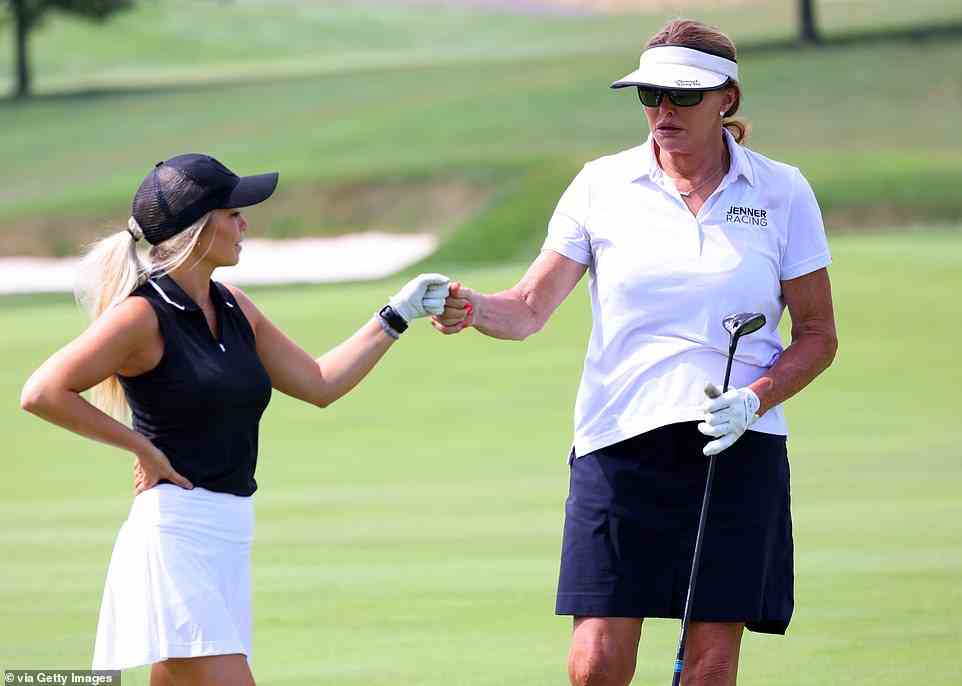 Hailey Ostrom and Caitlyn Jenner fist bump on the first hole during the pro-am prior to the LIV Golf Invitational - Bedminster at Trump National Golf Club Bedminster on July 28, 2022
