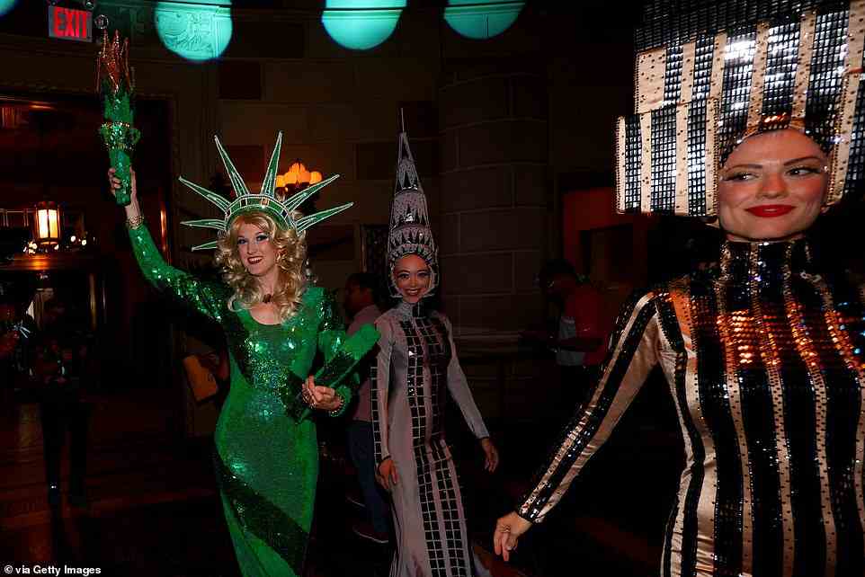 Entertainers are seen dressed in iconic New York City costumes during the welcome party for the LIV Golf Invitational - Bedminster at Gotham Hall